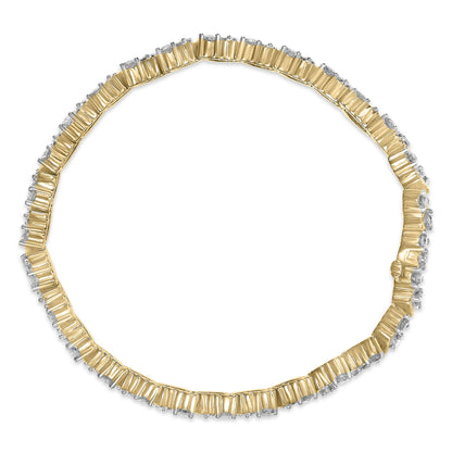 Top-down view of a yellow metal bracelet with round white gemstones in three-prong settings encircling the band.