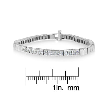 Front angle view of a white metal bracelet with a row of princess-shaped white gemstones in invisible setting, displayed above a ruler for size reference.