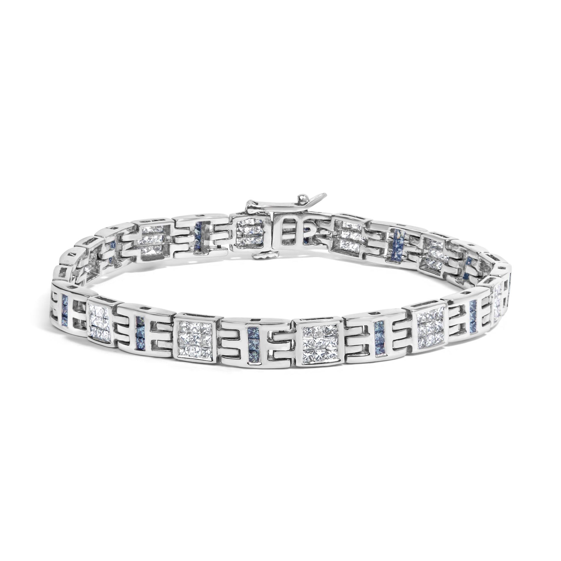 White metal bracelet with alternating square clusters of white gemstones in invisible setting and vertical rows of blue gemstones in channel setting, shown from a front angled view.