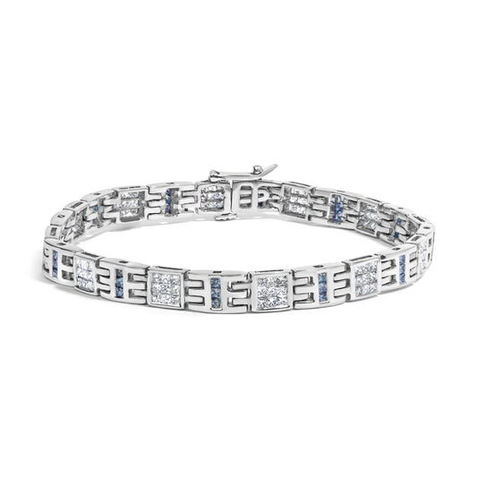 White metal bracelet with alternating square clusters of white gemstones in invisible setting and vertical rows of blue gemstones in channel setting, shown from a front angled view.