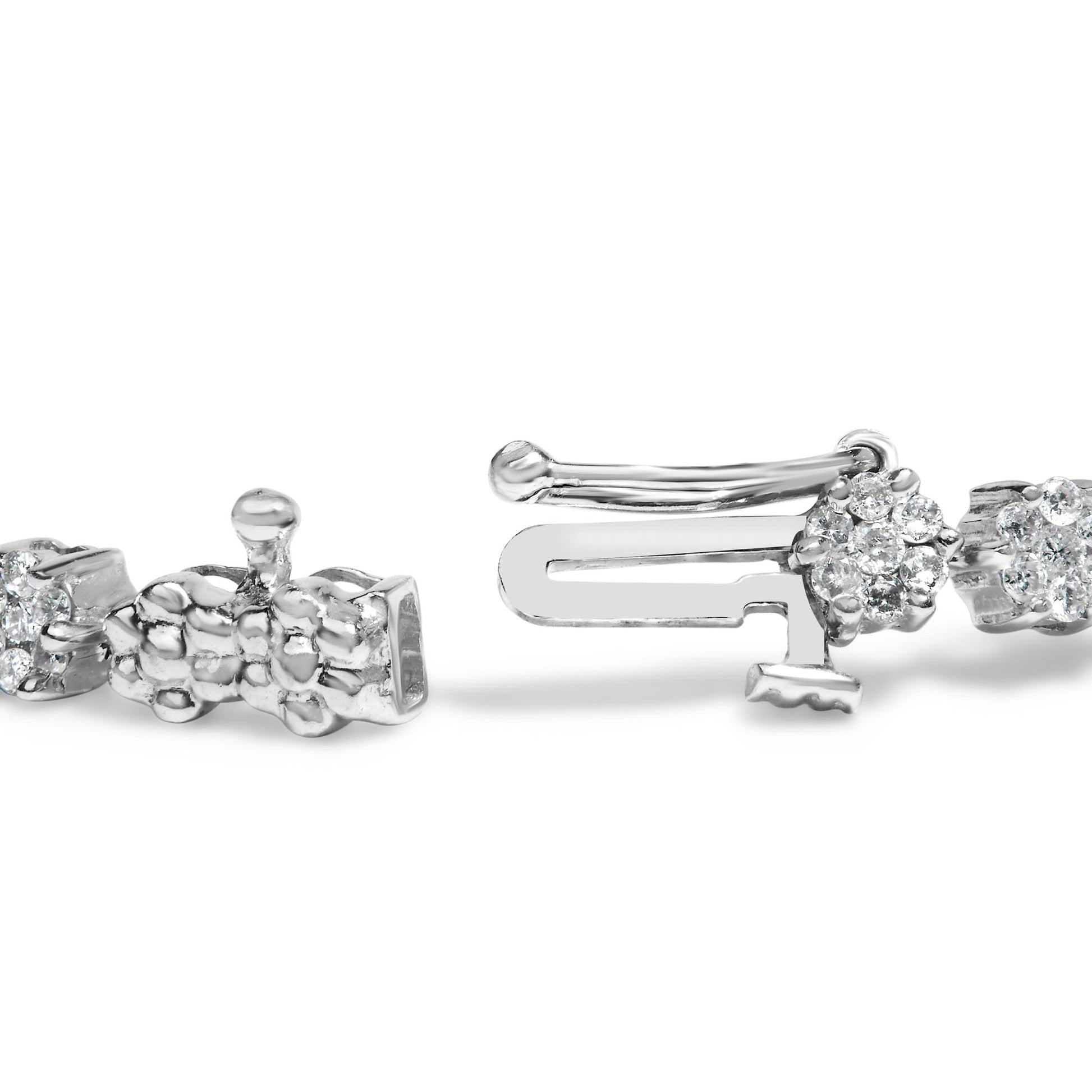 Close-up front angle of a white metal bracelet clasp with round white gemstones in prong settings.