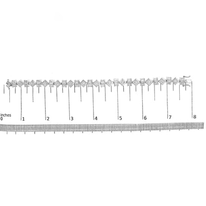 White metal bracelet with alternating princess and baguette shaped white gemstones, shown laid flat on a ruler scale from above.