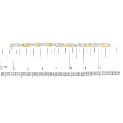 Yellow metal bracelet with alternating square sections set with white princess shape gemstones in an invisible setting and smaller baguette shape gemstones in a channel setting, shown flat on a ruler scale from a top-down angle.