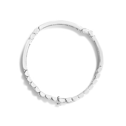 Top-down view of a white metal bracelet with smooth, rounded links and a small dangling charm.