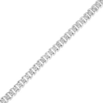 Diagonal close-up of a white metal bracelet with round white gemstones in a miracle setting.