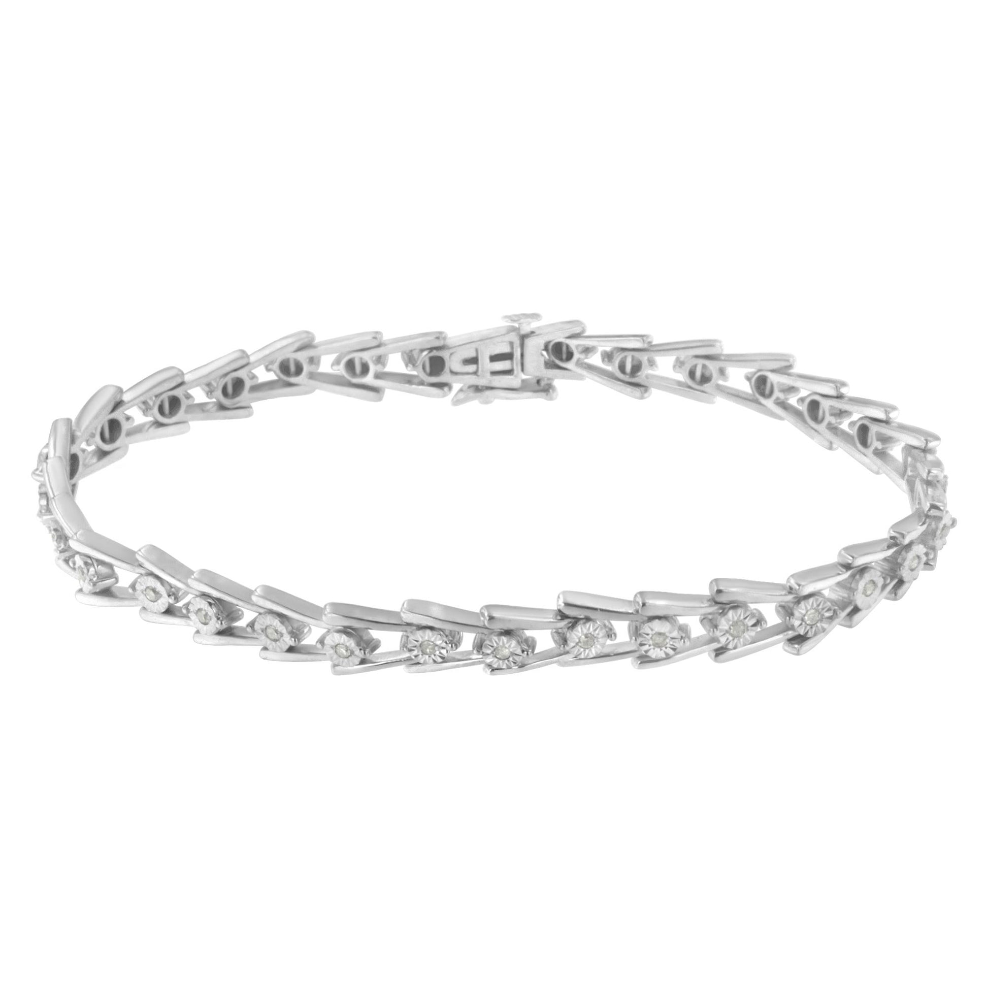 White metal bracelet with round white gemstones set in a miracle setting, displayed in a top-down flat lay angle.