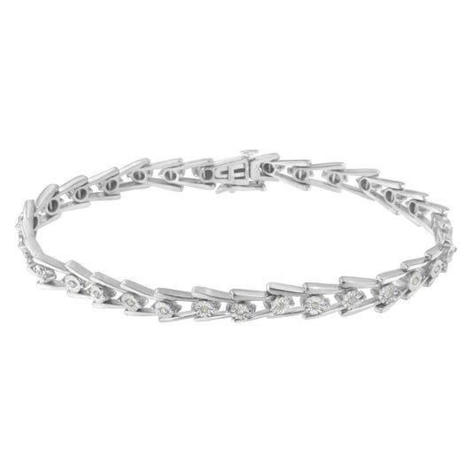 White metal bracelet with round white gemstones set in a miracle setting, displayed in a top-down flat lay angle.