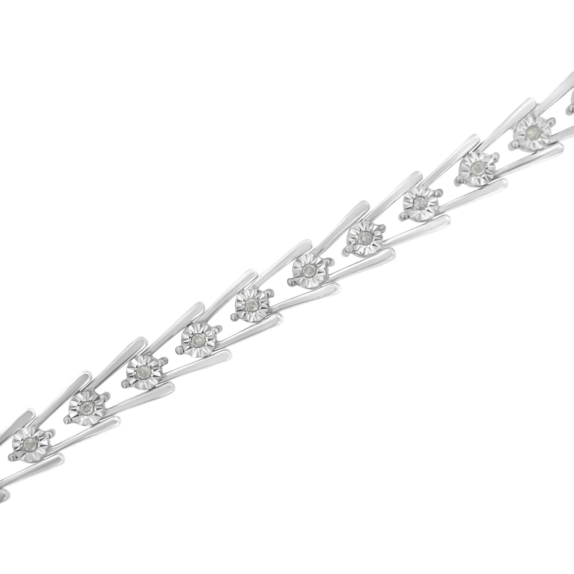 Diagonal close-up of a white metal bracelet featuring round white gemstones set in a miracle setting.