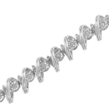 White metal bracelet with round white gemstones set in a spiral design, shown from a diagonal close-up angle.