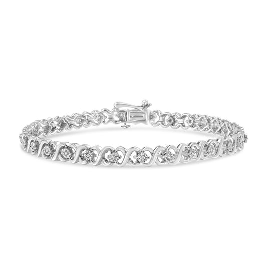White metal bracelet with round white gemstones in miracle setting along the band, shown in a front angled close-up.