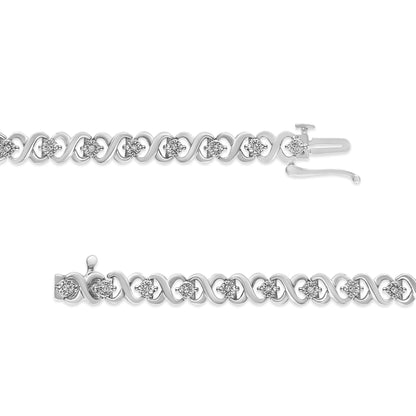 Top view of a white metal bracelet with round white gemstones set in a repeating loop design, showing the clasp open.