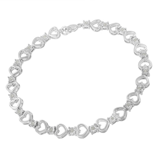 White metal heart-shaped linked bracelet with round white gemstones in miracle settings, displayed flat from a top-down angle.
