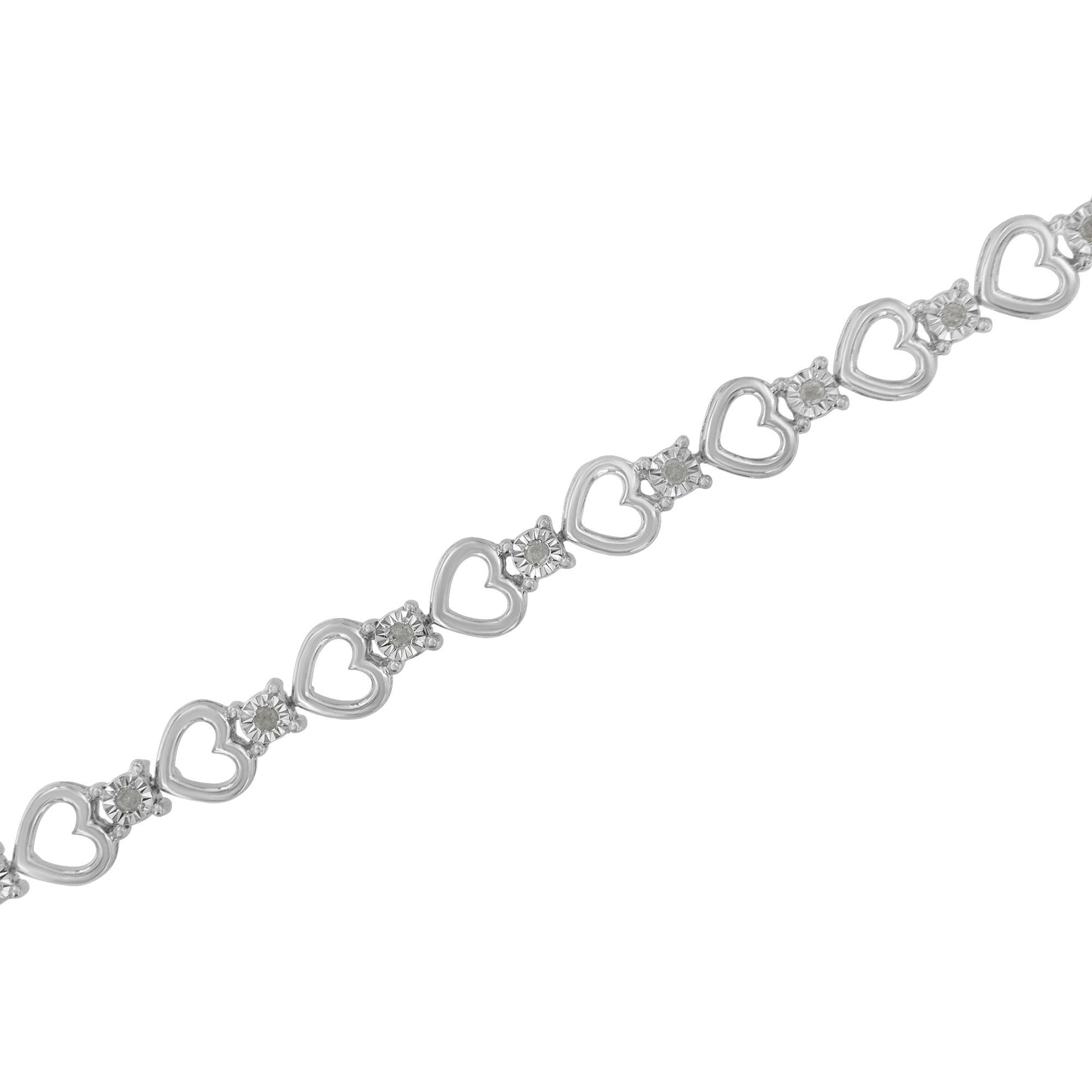 Diagonal close-up of a white metal bracelet with alternating heart shapes and round white gemstones in miracle settings.