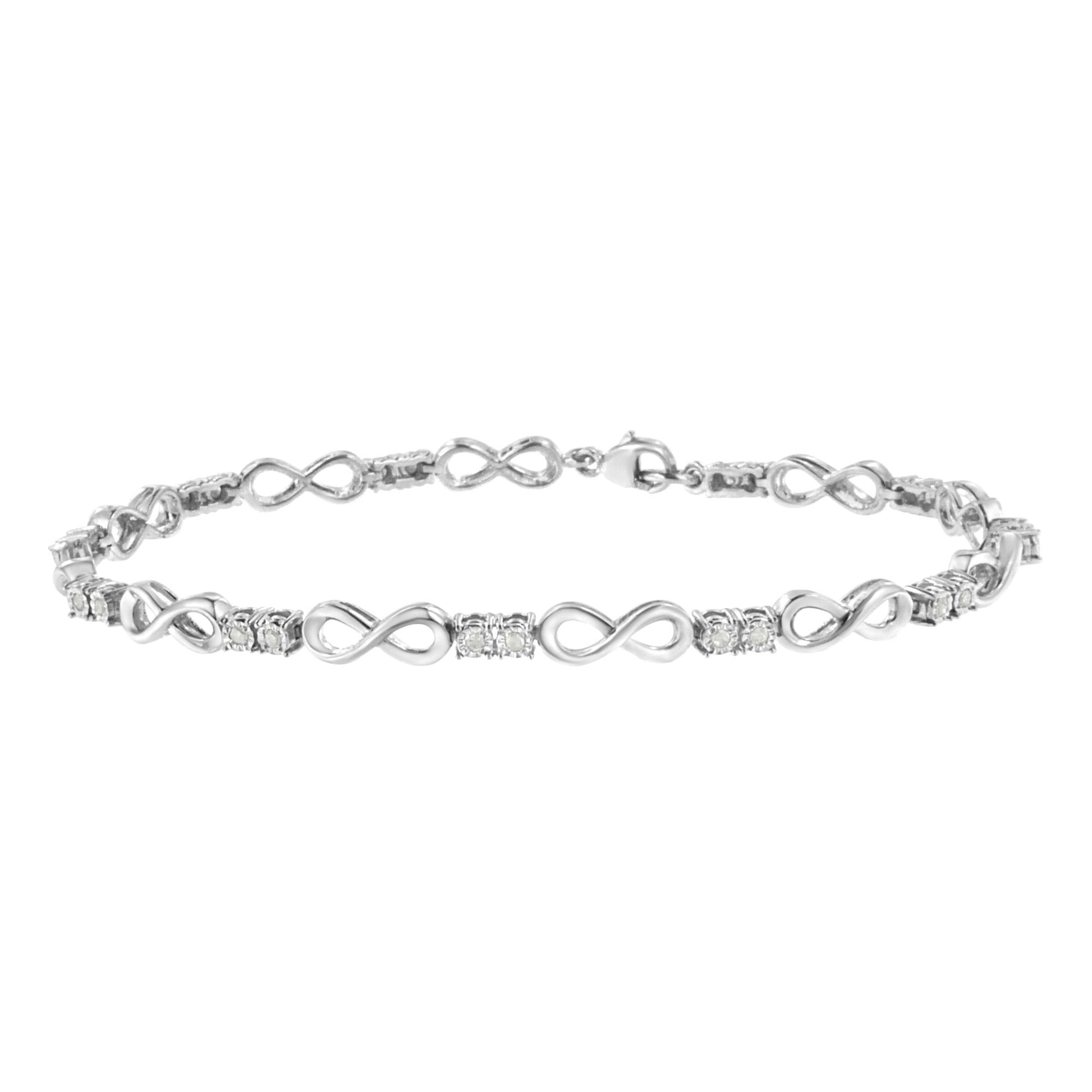 White metal bracelet with alternating infinity symbol links and clusters of round white gemstones in miracle settings, shown in a front-facing close-up shot.