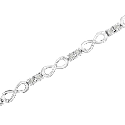 White metal bracelet with alternating infinity-shaped links and clusters of round white gemstones set in a Miracle setting, shown in a diagonal close-up angle.