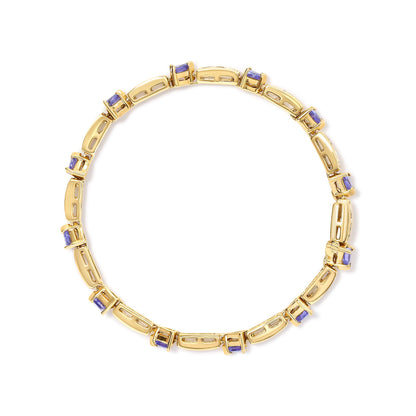 Top-down view of a yellow bracelet with alternating rectangular links and blue trillion-shaped gemstones in prong settings. White round gemstones set in channels are visible on the rectangular links.