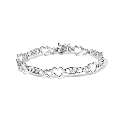 White metal heart-link bracelet with round white gemstones in prong settings, shown from a front-facing angle on a white background.