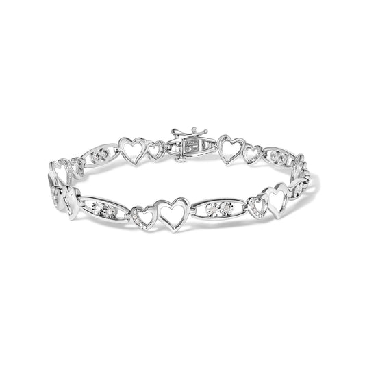 White metal heart-link bracelet with round white gemstones in prong settings, shown from a front-facing angle on a white background.