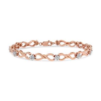 Rose metal bracelet with intertwined design and round white gemstones in a pave setting, shown from a front angled view.