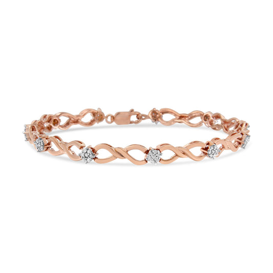 Rose metal bracelet with intertwined design and round white gemstones in a pave setting, shown from a front angled view.