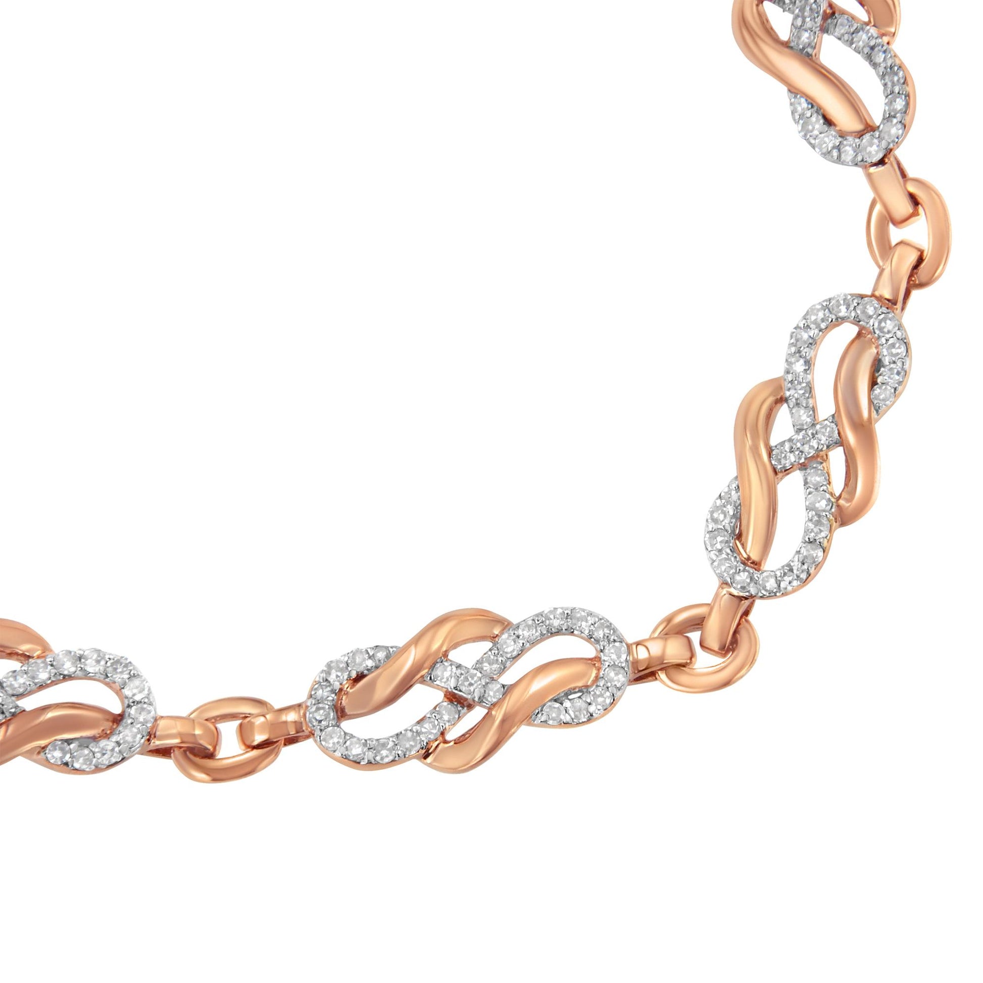 Close-up angled view of a rose-colored bracelet with alternating links, some featuring white round pave-set gemstones.