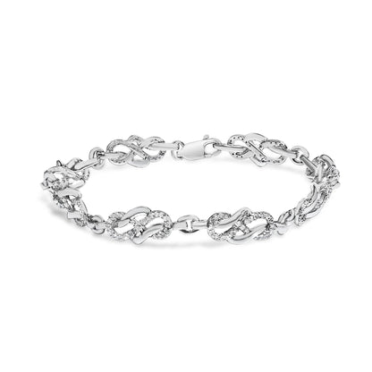 White metal bracelet with linked sections featuring pave set round white gemstones, shown in a front-facing isolated view.