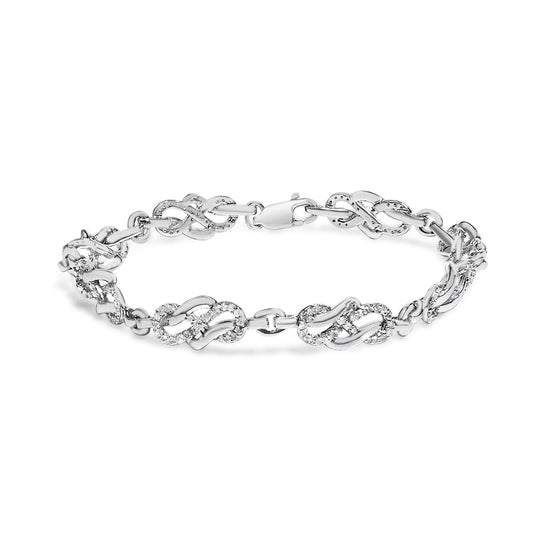 White metal bracelet with linked sections featuring pave set round white gemstones, shown in a front-facing isolated view.