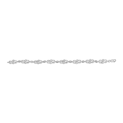White metal bracelet with linked oval-shaped sections featuring round white gemstones in pave setting, shown flat against a white background from a top-down angle.
