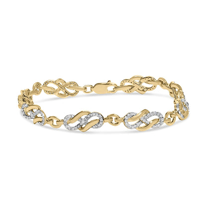 Yellow metal bracelet with alternating infinity-shaped links, some decorated with pave-set round white gemstones, shown in a front angled view.