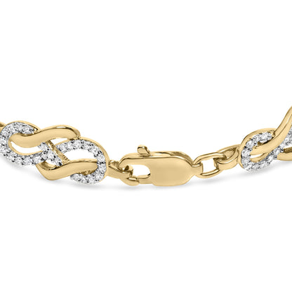 Close-up front angle of a yellow metal bracelet featuring interlocking links, some set with small round white gemstones in a pave setting, with a lobster clasp.