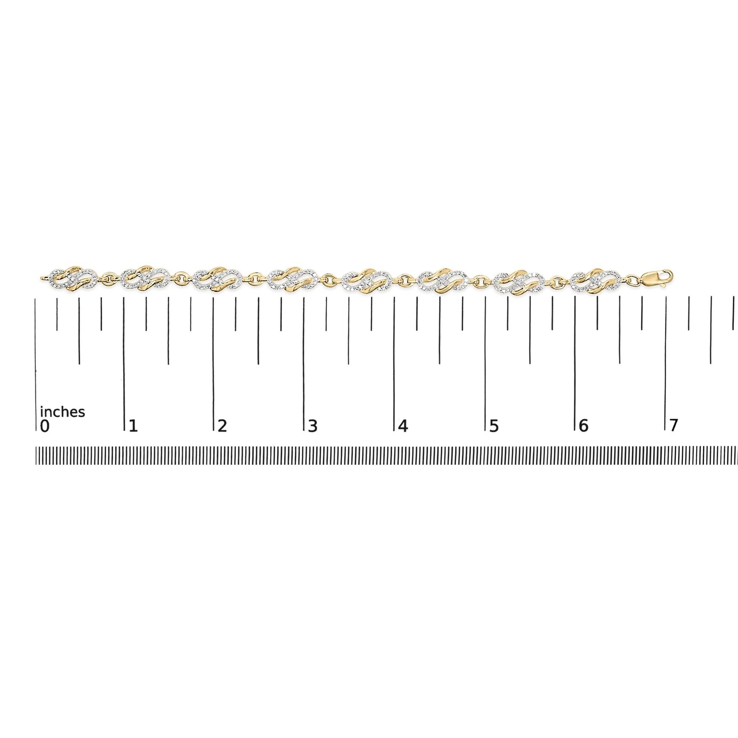 Yellow metal bracelet with linked oval-shaped sections featuring white gemstones in pave setting, shown laying flat on a ruler scale, top-down view.