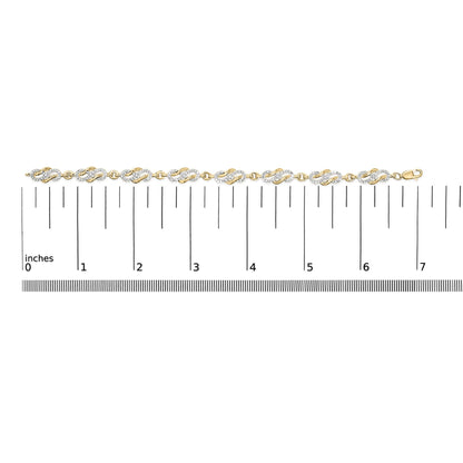 Yellow metal bracelet with linked oval-shaped sections featuring white gemstones in pave setting, shown laying flat on a ruler scale, top-down view.