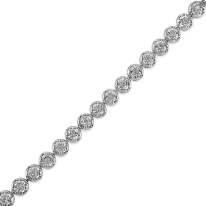 Diagonal close-up top view of a white metal bracelet featuring round-shaped white gemstones in prong settings arranged in a linked pattern.