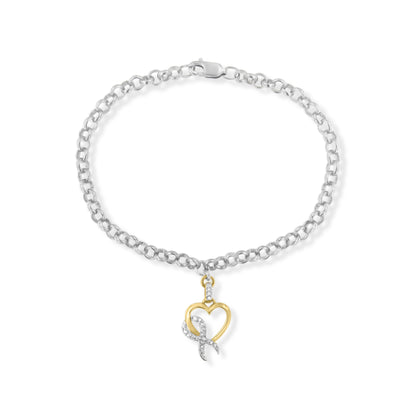 Top-down view of a two-toned bracelet with a round linked chain and a heart-shaped pendant featuring white gemstones.