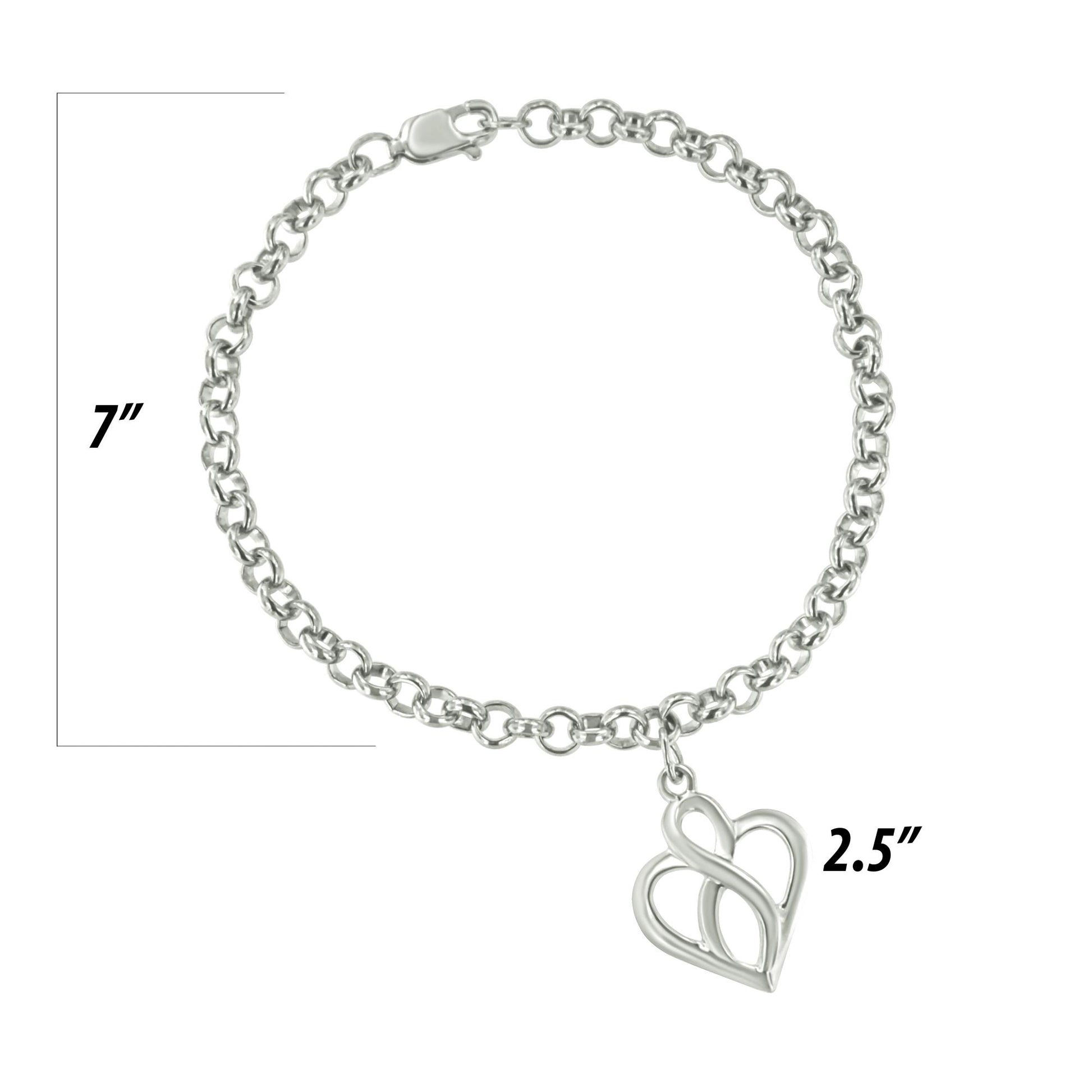 Top-down view of a white metal chain bracelet with a heart-shaped charm, displayed on a ruler for size reference.