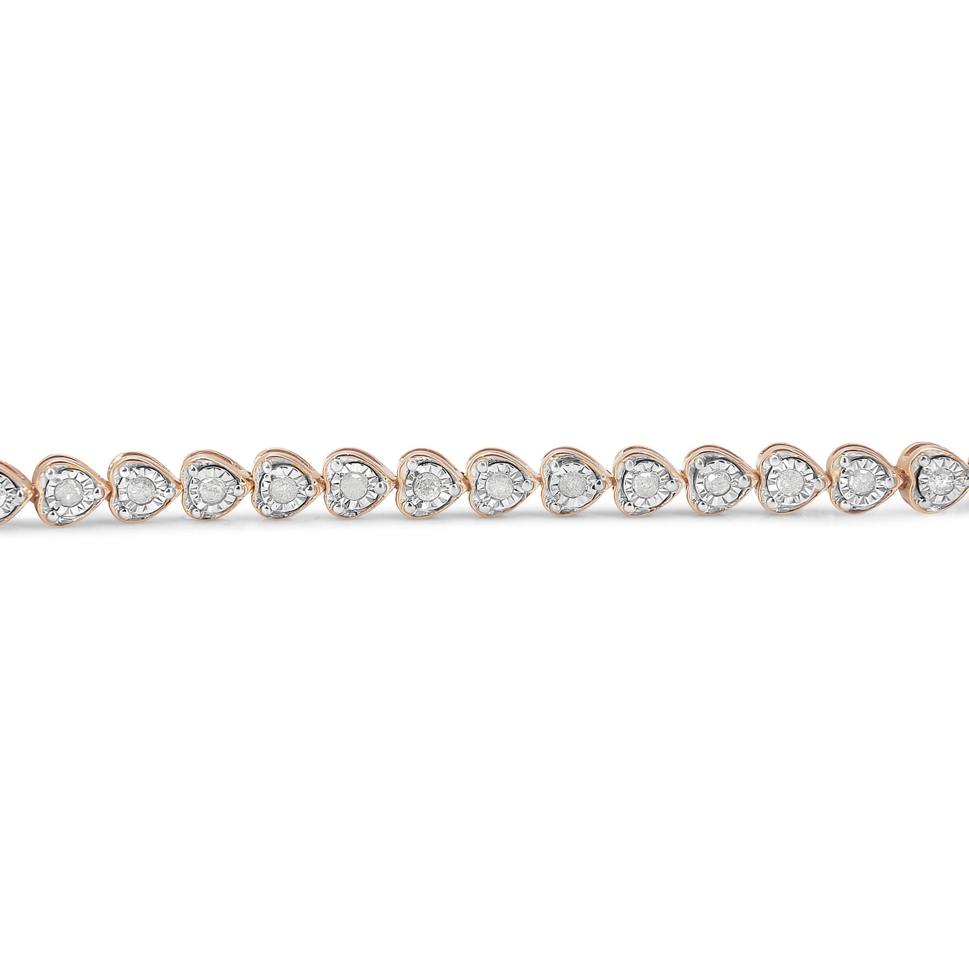 Close-up front view of a rose-colored bracelet featuring a continuous line of heart-shaped settings, each with a round white gemstone in a miracle setting.