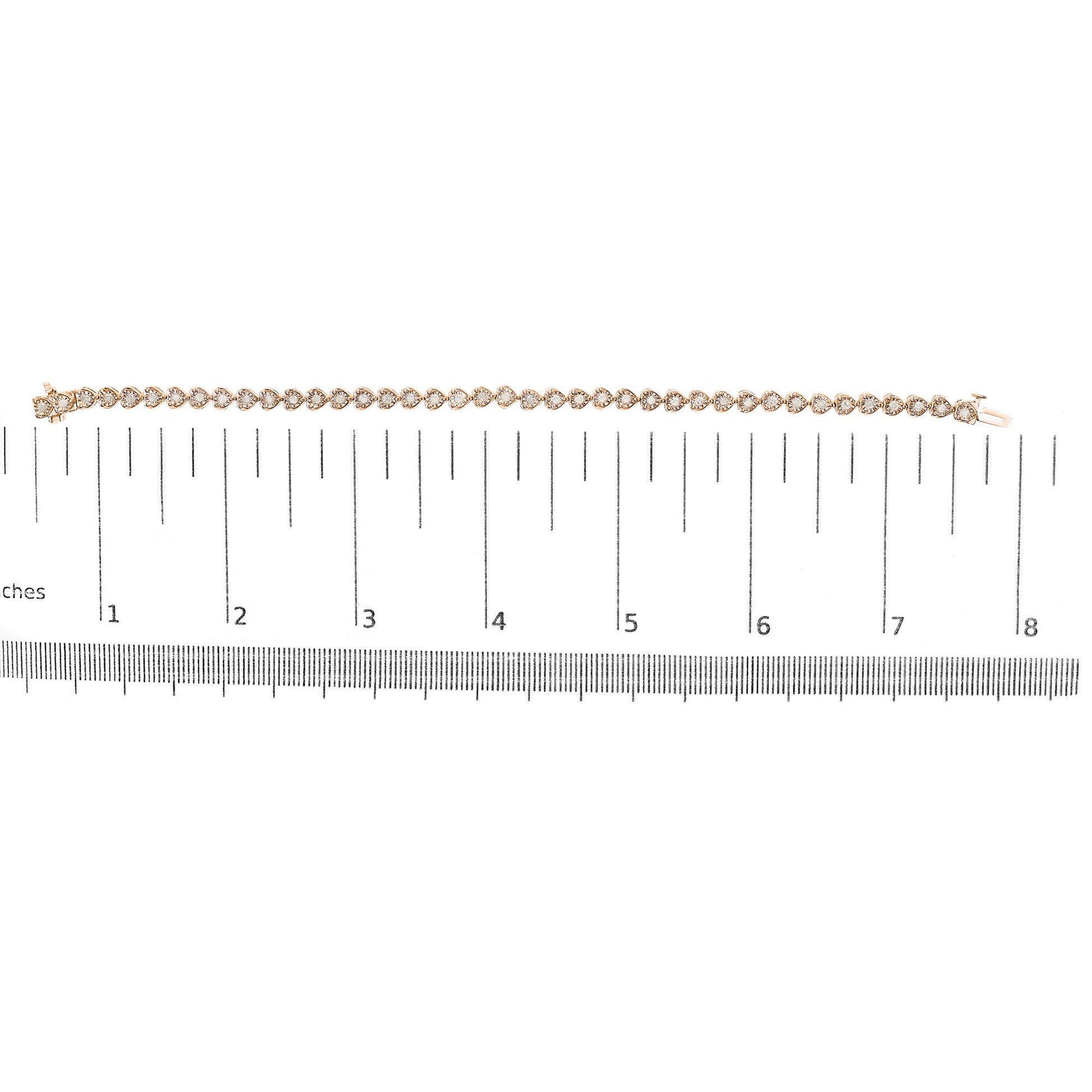 Rose-colored bracelet with round white gemstones in miracle setting, laid flat on a ruler for size reference, top-down view.