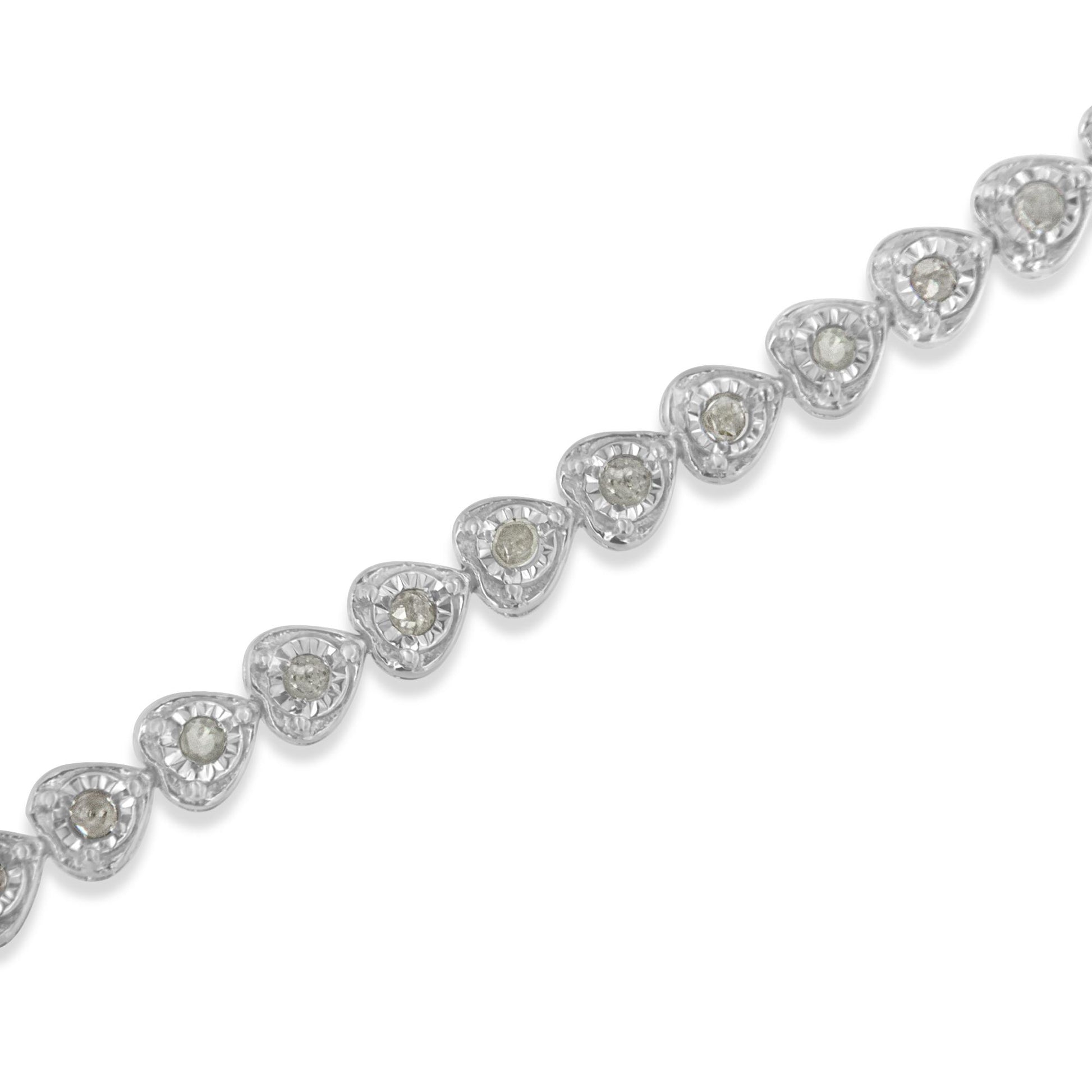 Diagonal close-up of a white metal bracelet featuring a series of heart-shaped links, each set with a round white gemstone in a miracle setting.