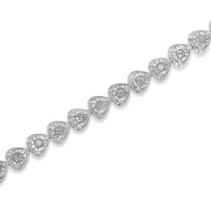 Diagonal close-up of a white metal bracelet featuring a series of heart-shaped links, each set with a round white gemstone in a miracle setting.