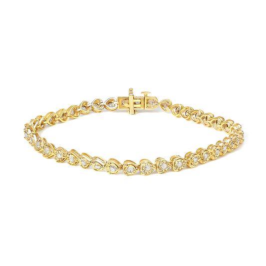 Yellow metal bracelet with round white gemstones in a miracle setting, shown from a top angled view.