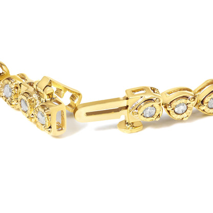 Close-up angled view of a yellow metal bracelet with round white gemstones in a miracle setting, showing the clasp open.