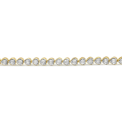 Straight-on view of a yellow bracelet featuring heart-shaped links, each set with a round white gemstone in a miracle setting.