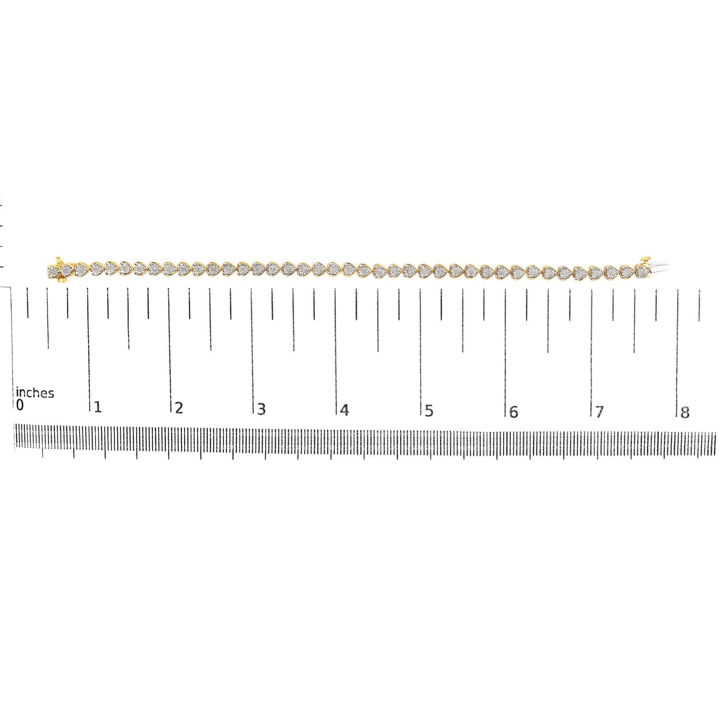 Yellow metal bracelet with round white gemstones in miracle setting, displayed horizontally on a ruler for size reference, front facing shot.