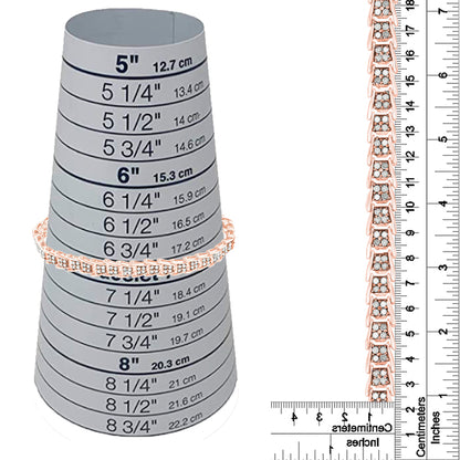Rose metal bracelet with white round gemstones in prong settings, shown on a size measuring cone and next to rulers for size reference, displayed from a front angle.