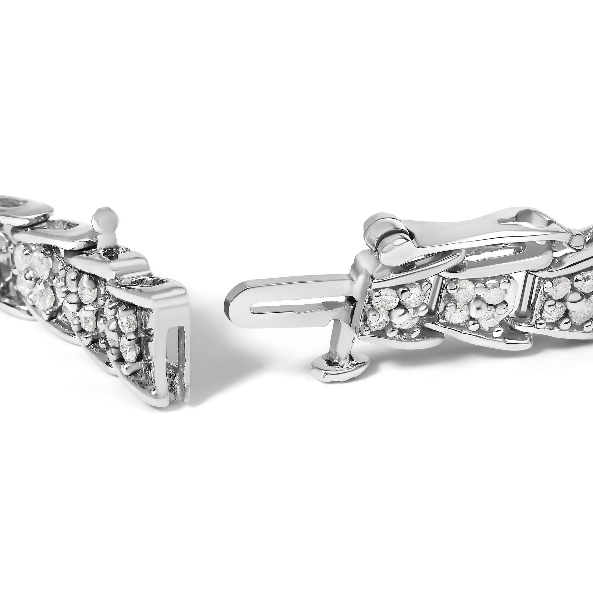 Close-up front angle of a white metal bracelet clasp with multiple prong-set round white gemstones.