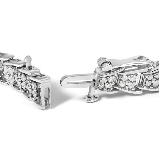 Close-up front angle of a white metal bracelet clasp with multiple prong-set round white gemstones.