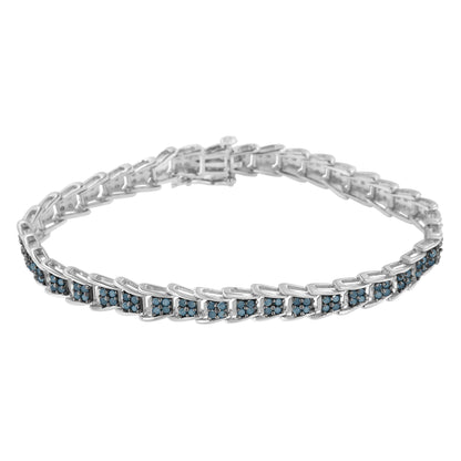 White metal bracelet with blue round gemstones in prong settings, shown from a front angle.