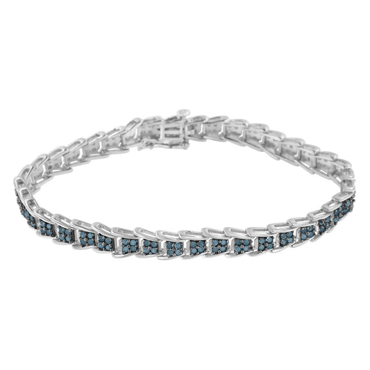 White metal bracelet with blue round gemstones in prong settings, shown from a front angle.