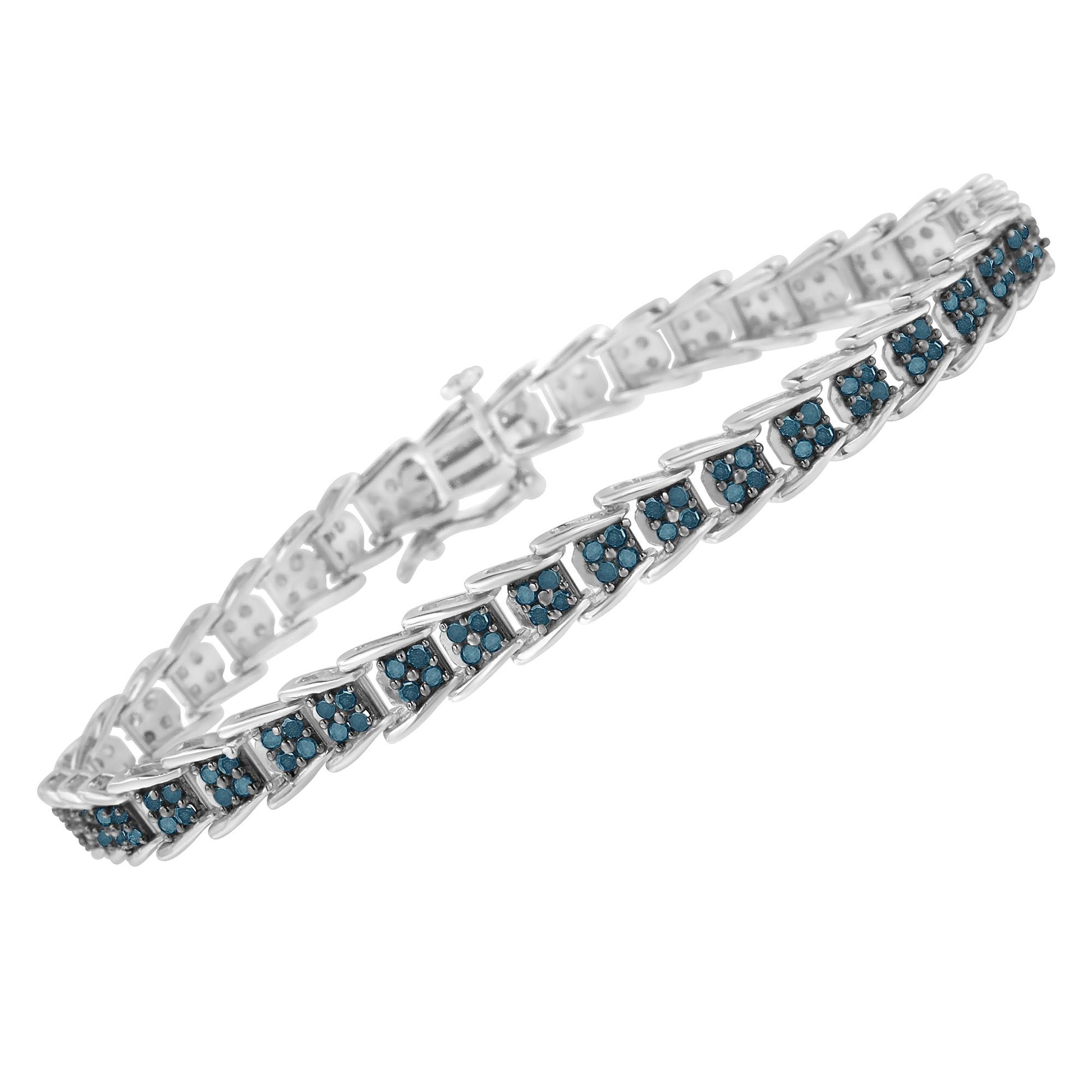 White metal bracelet with linked rectangular sections each set with small round blue gemstones, shown at an angle.