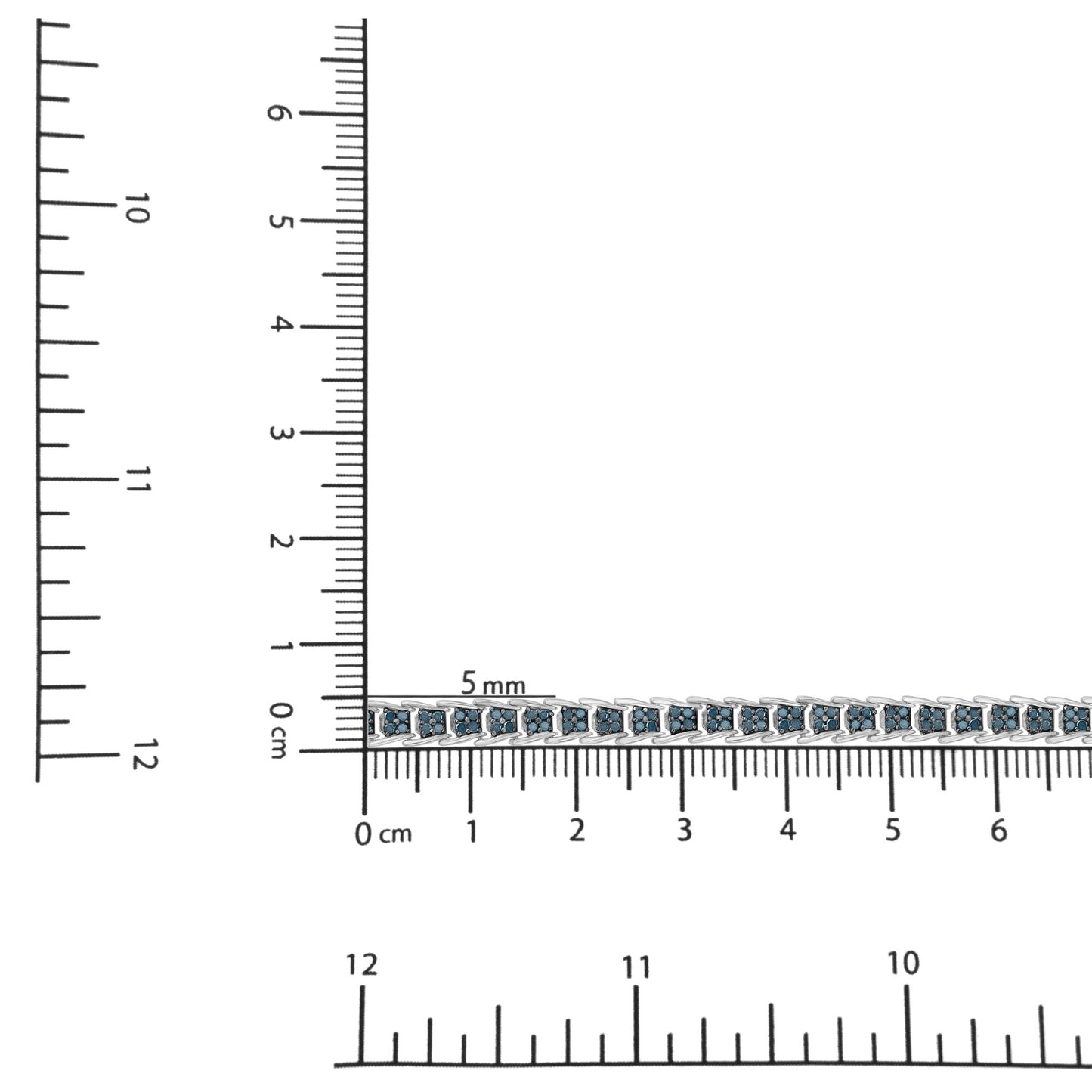 White metal bracelet with blue round gemstones in prong settings, shown on a ruler for size reference, photographed from a top-down angle.